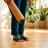 Les chaussons Pitlam vert et noir sont aux pieds d'une yogini avant sa séance de yoga - My Shop Yoga